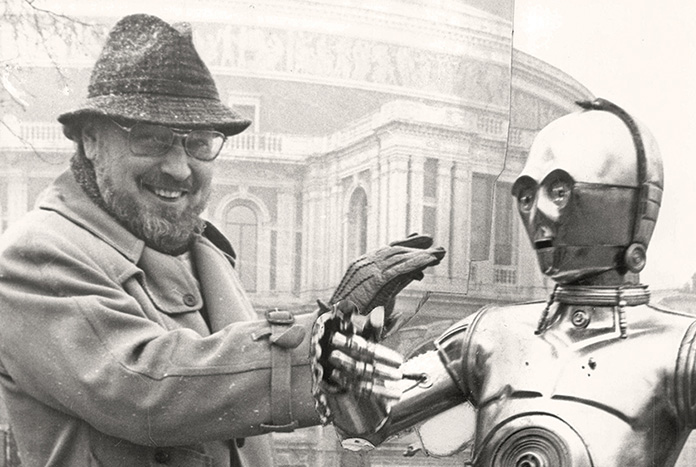 Composer John Williams With Anthony Daniels As C3po And R2d2 At Star Wars Concert. John Towner Williams (born February 8 1932) Is An American Composer Conductor And Pianist. In A Career Spanning Almost Six Decades He Has Composed Some Of The Most Rec